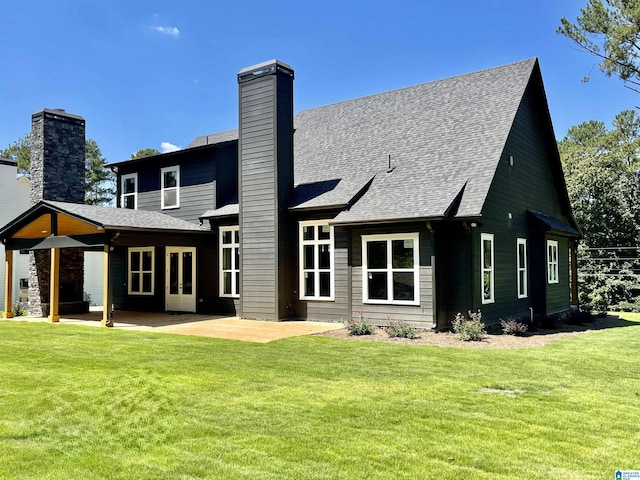 rear view of house featuring a yard and a patio