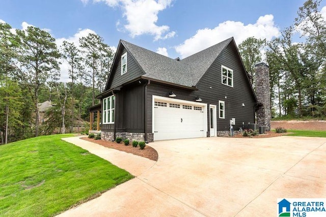 view of home's exterior with a chimney, a lawn, board and batten siding, cooling unit, and driveway