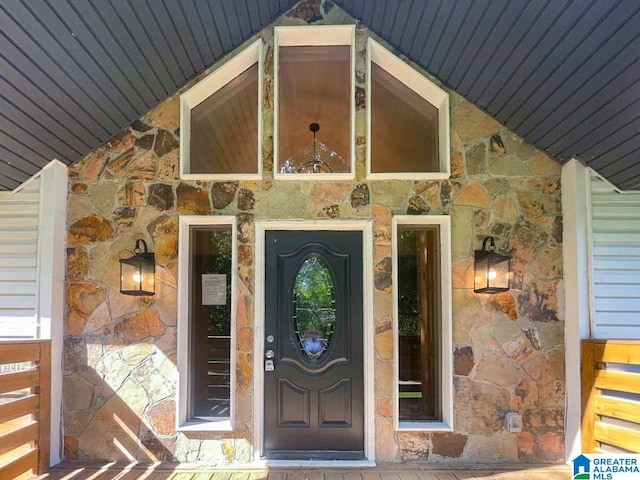 property entrance featuring stone siding