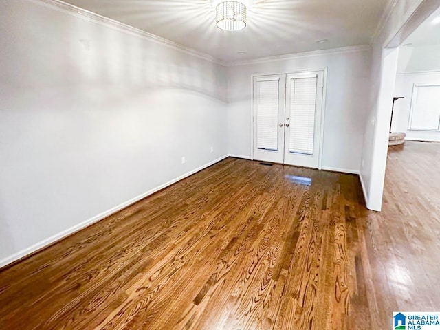 unfurnished room featuring french doors, hardwood / wood-style floors, and ornamental molding