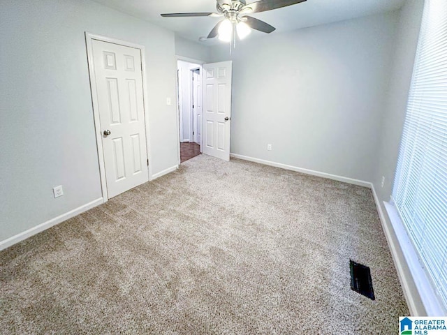 unfurnished bedroom with carpet floors, ceiling fan, and baseboards