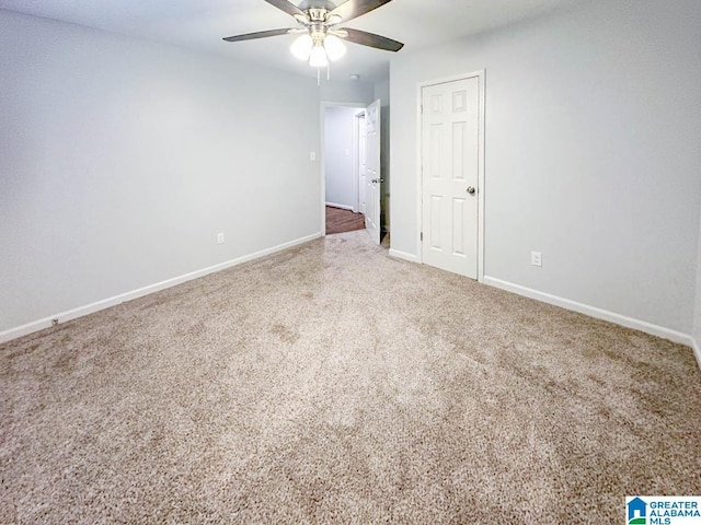 unfurnished room with carpet flooring, ceiling fan, and baseboards