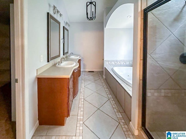 bathroom with a sink, a whirlpool tub, tile patterned flooring, and a shower stall