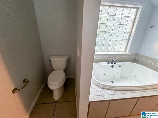 bathroom with toilet and a relaxing tiled tub