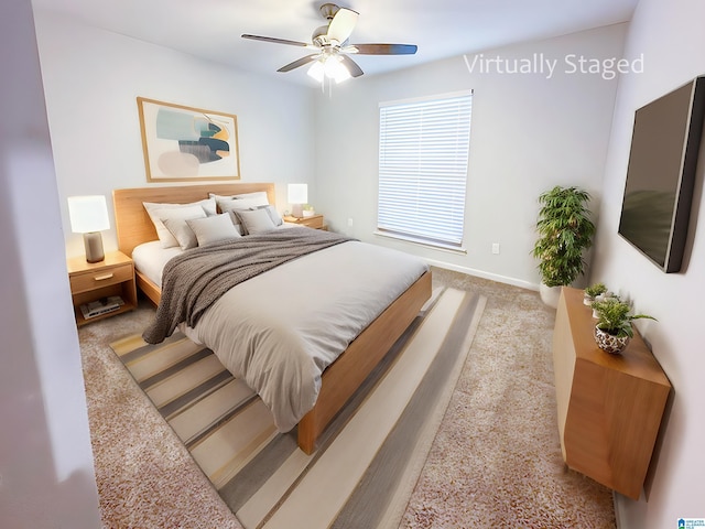 carpeted bedroom with a ceiling fan and baseboards