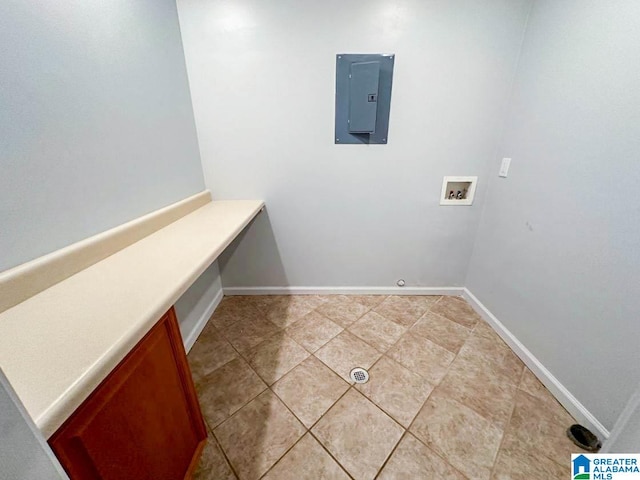 laundry area with electric panel, washer hookup, and tile patterned flooring