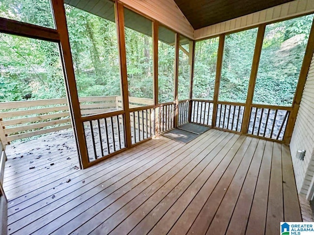 unfurnished sunroom featuring vaulted ceiling