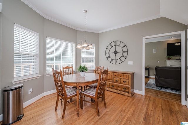 dining space with light wood finished floors, baseboards, an inviting chandelier, and ornamental molding