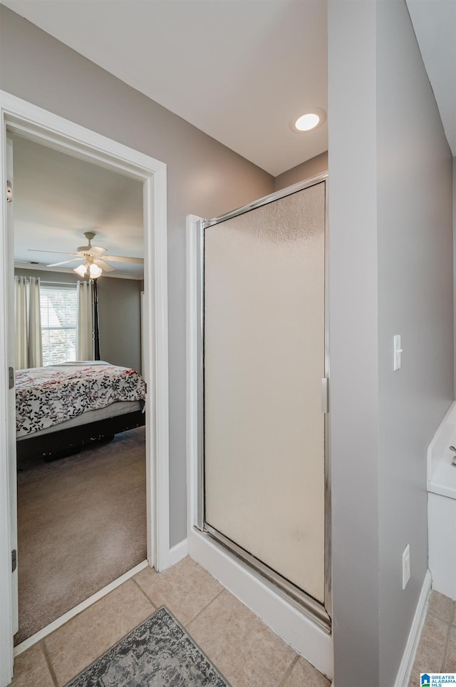 bathroom with an enclosed shower, ceiling fan, and tile patterned floors