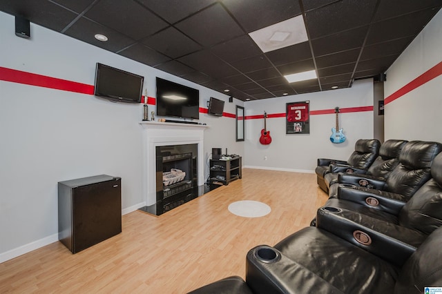 living room with hardwood / wood-style floors and a paneled ceiling