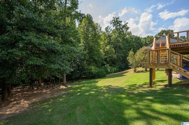 view of yard featuring a wooden deck and stairway