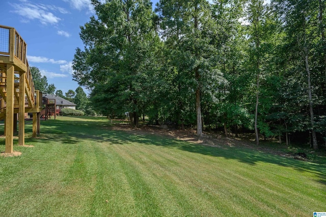 view of yard featuring stairway and a wooden deck
