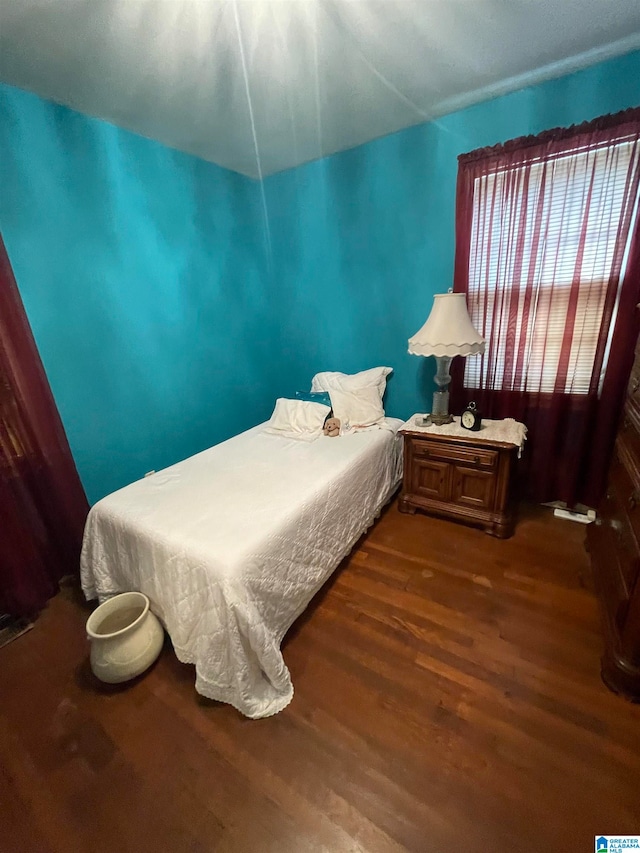 bedroom featuring dark hardwood / wood-style flooring