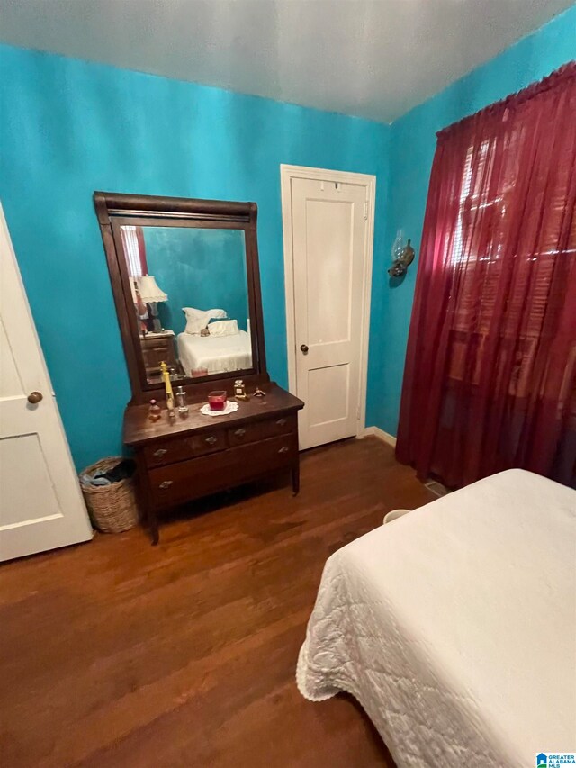 bedroom featuring dark hardwood / wood-style flooring