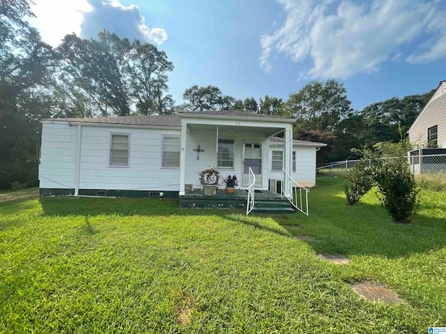 bungalow-style home featuring a front lawn and covered porch