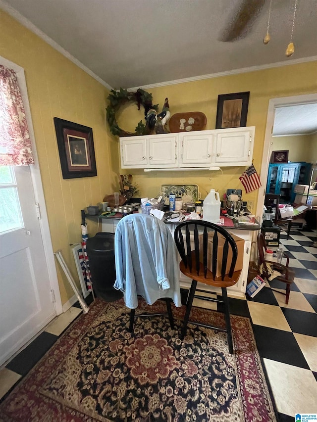 dining area with crown molding, ceiling fan, and light tile patterned floors