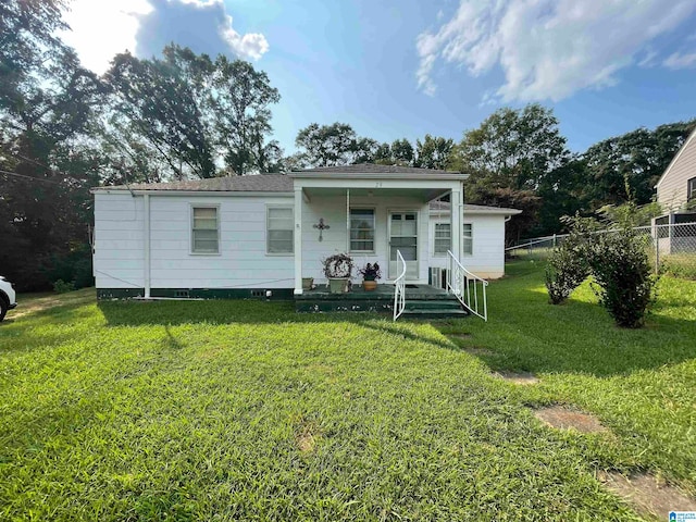 back of house with a lawn