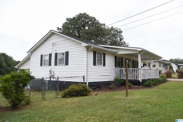 view of side of property featuring a yard and covered porch