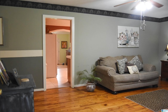 living room with wood-type flooring and ceiling fan