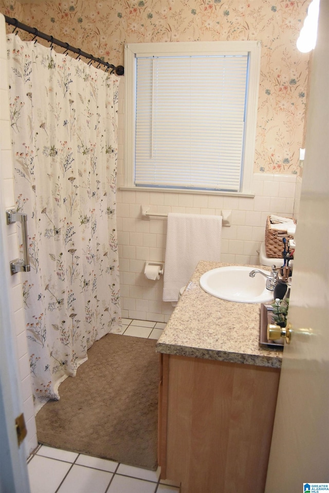 bathroom featuring vanity, tile walls, tile patterned floors, and walk in shower