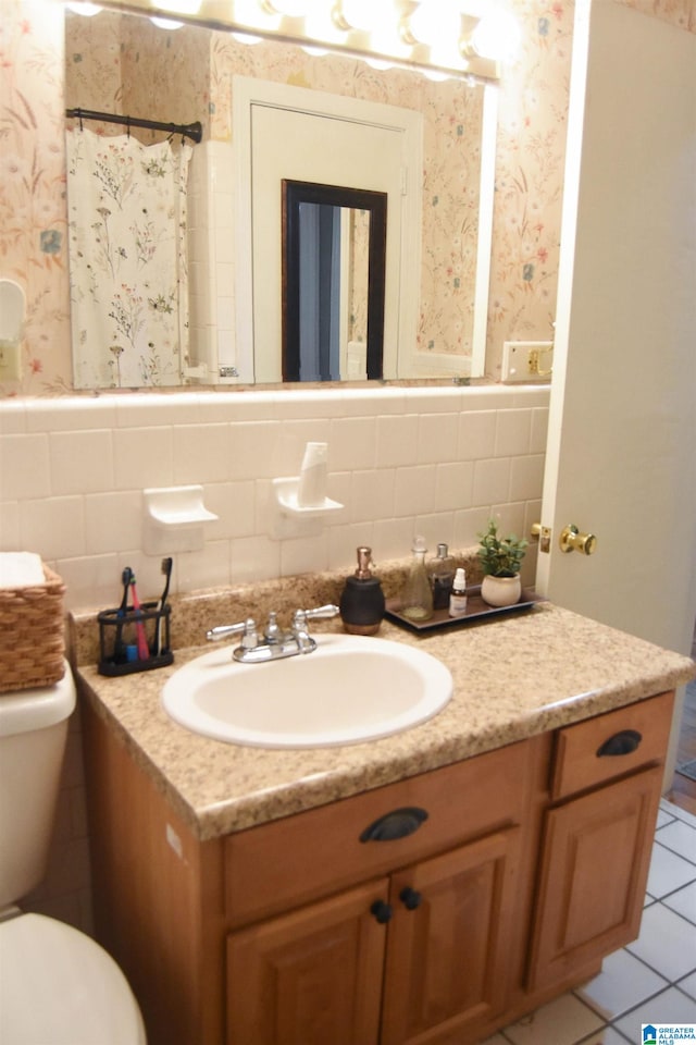 bathroom featuring tile patterned floors, walk in shower, toilet, tasteful backsplash, and vanity