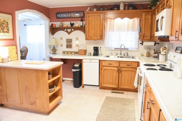 kitchen with backsplash, sink, tile countertops, and white appliances