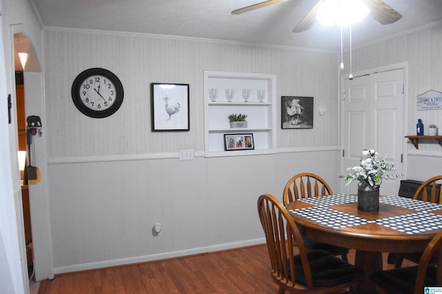 dining room with ceiling fan, ornamental molding, and hardwood / wood-style flooring