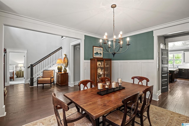 dining area with a chandelier, dark hardwood / wood-style floors, and crown molding