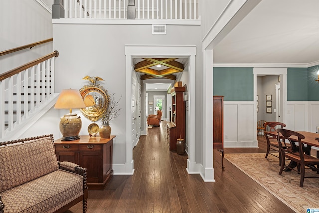 hallway featuring dark hardwood / wood-style flooring and crown molding