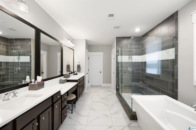 bathroom featuring vanity and shower with separate bathtub