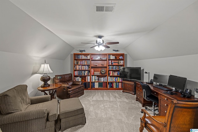 carpeted office space with ceiling fan and vaulted ceiling