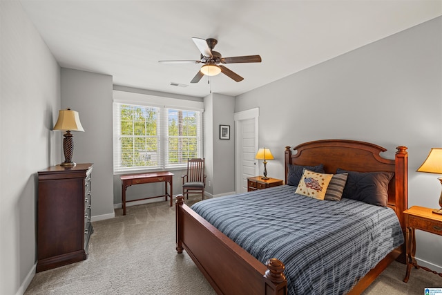 bedroom featuring light colored carpet and ceiling fan