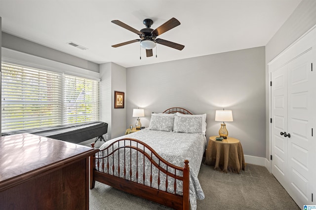 carpeted bedroom with a closet and ceiling fan