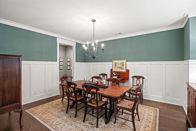 dining room with a notable chandelier, ornamental molding, and dark hardwood / wood-style floors