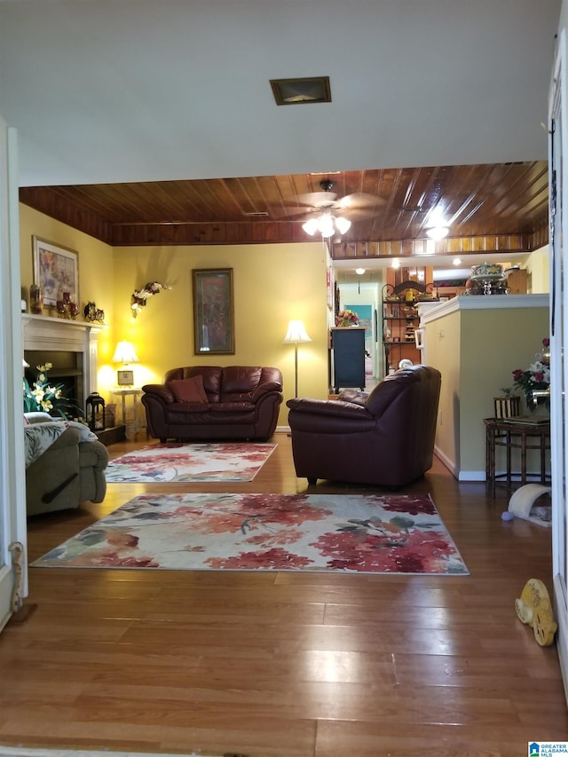 living room with ceiling fan, wood ceiling, and wood-type flooring