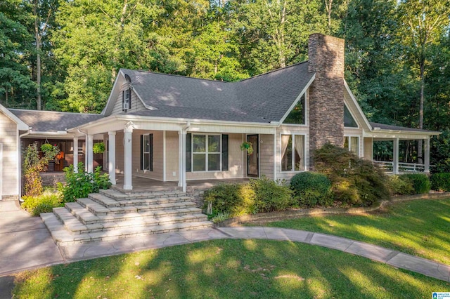 view of front of house with covered porch and a front yard