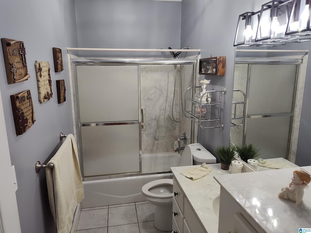 bathroom with bath / shower combo with glass door, vanity, toilet, and tile patterned floors