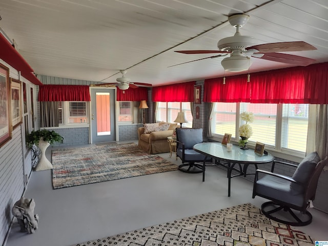 sunroom / solarium featuring a ceiling fan and a healthy amount of sunlight