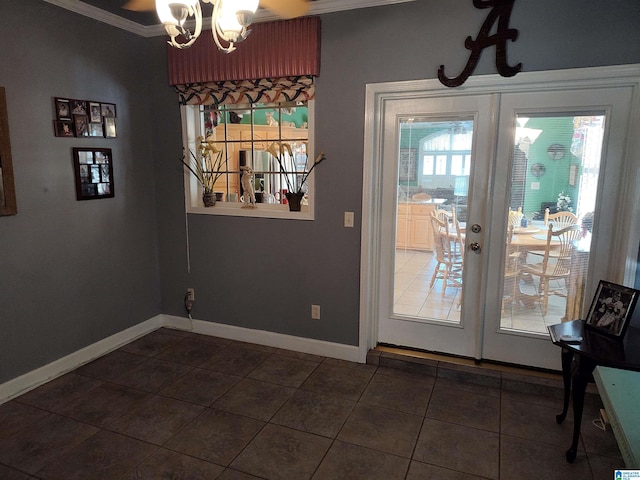 doorway with dark tile patterned flooring, french doors, an inviting chandelier, crown molding, and baseboards