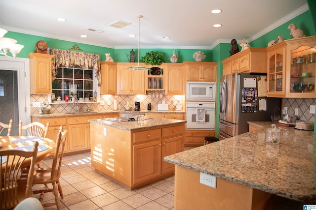 kitchen with white appliances, light brown cabinets, visible vents, ornamental molding, and glass insert cabinets