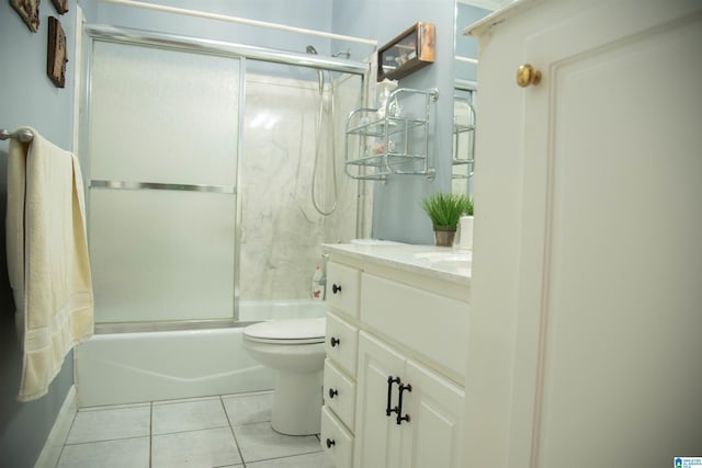 full bath featuring tile patterned floors, combined bath / shower with glass door, toilet, and vanity