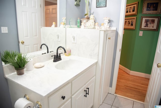 bathroom with vanity, tile patterned floors, and baseboards