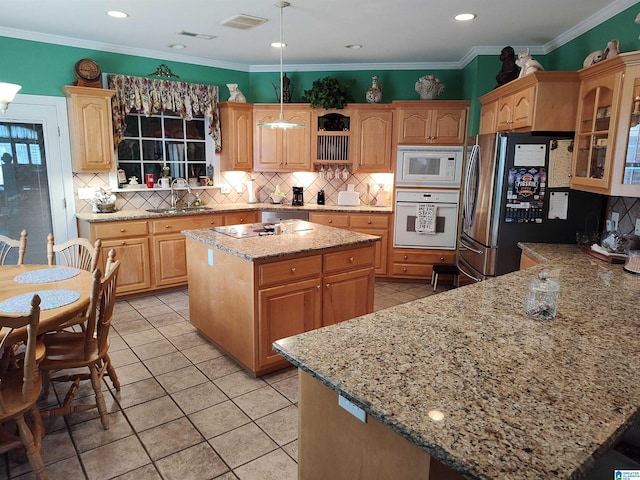 kitchen with visible vents, backsplash, ornamental molding, a sink, and white appliances