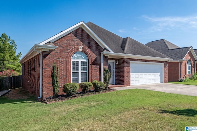 view of front of home with a garage and a front lawn