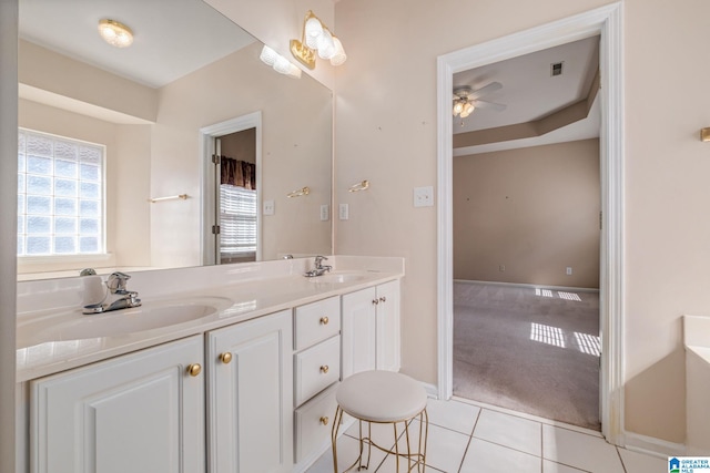 full bath featuring tile patterned floors, visible vents, double vanity, and a sink