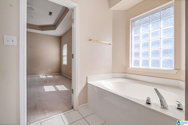 bathroom with a bathing tub and tile patterned floors