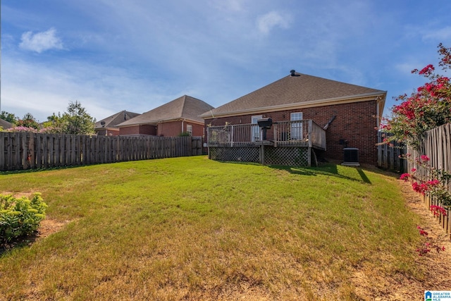 view of yard with central AC unit and a wooden deck