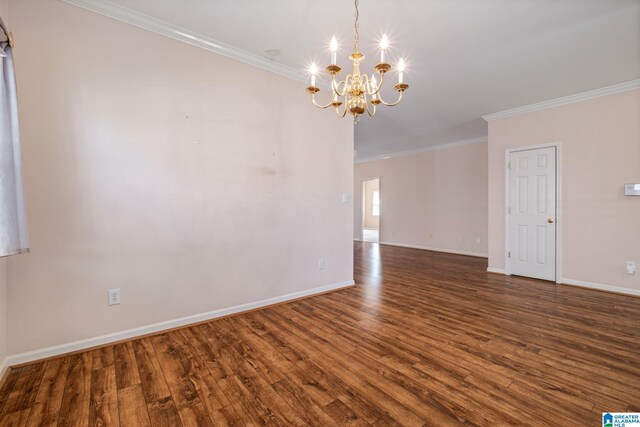 empty room featuring dark wood-type flooring, a notable chandelier, and ornamental molding