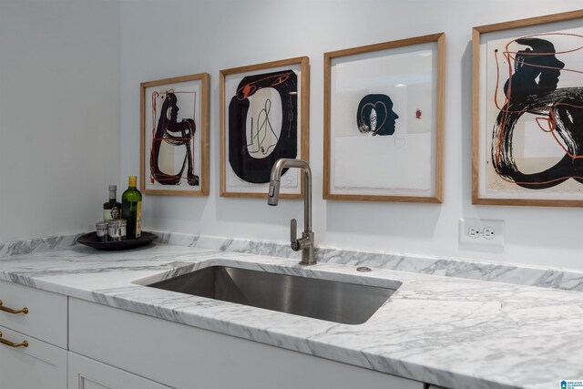 kitchen with sink and light stone countertops