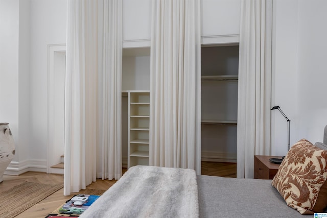 bedroom featuring light hardwood / wood-style flooring and two closets